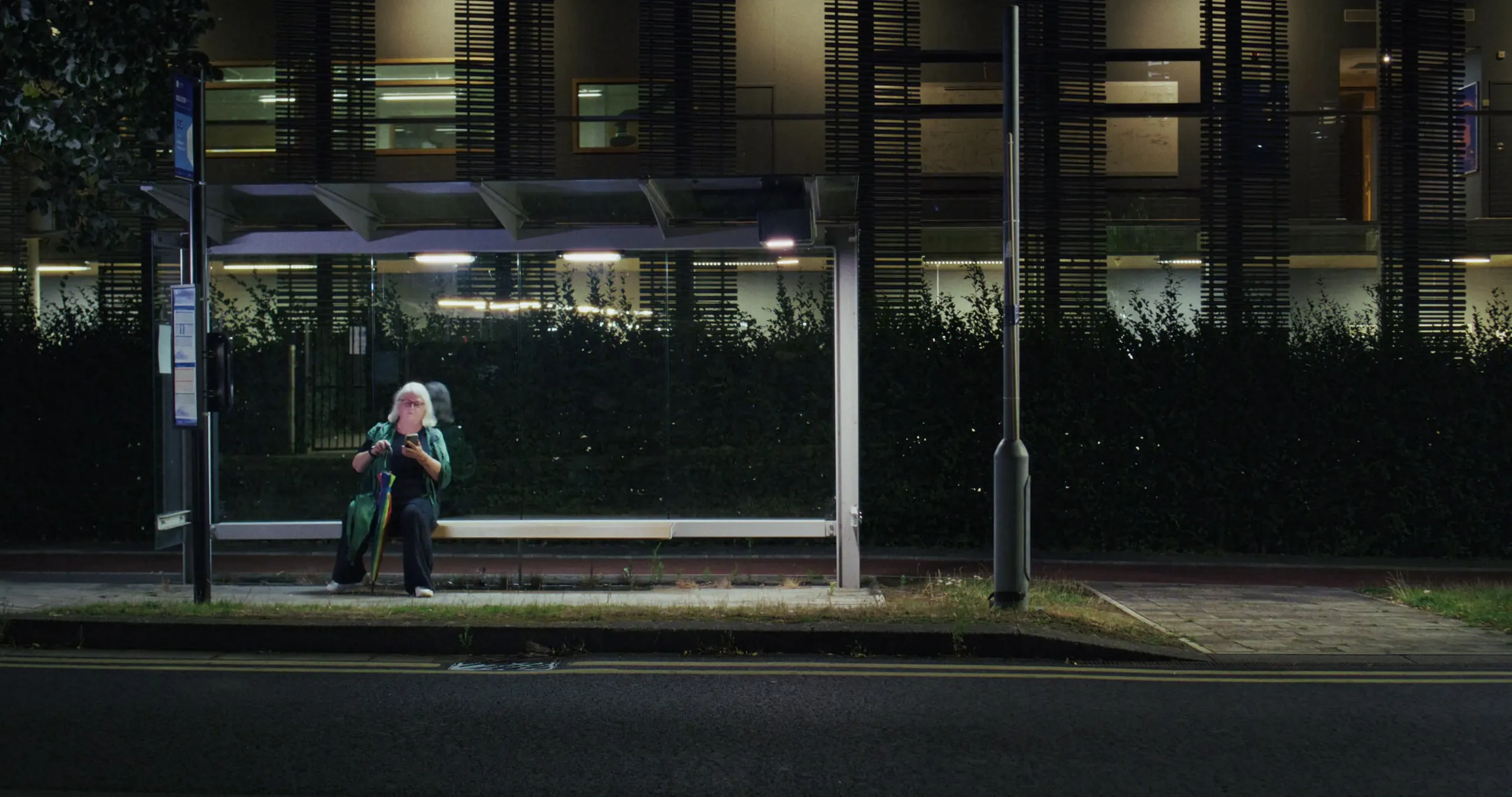 Susan Rees sits alone in the bus shelter at night
